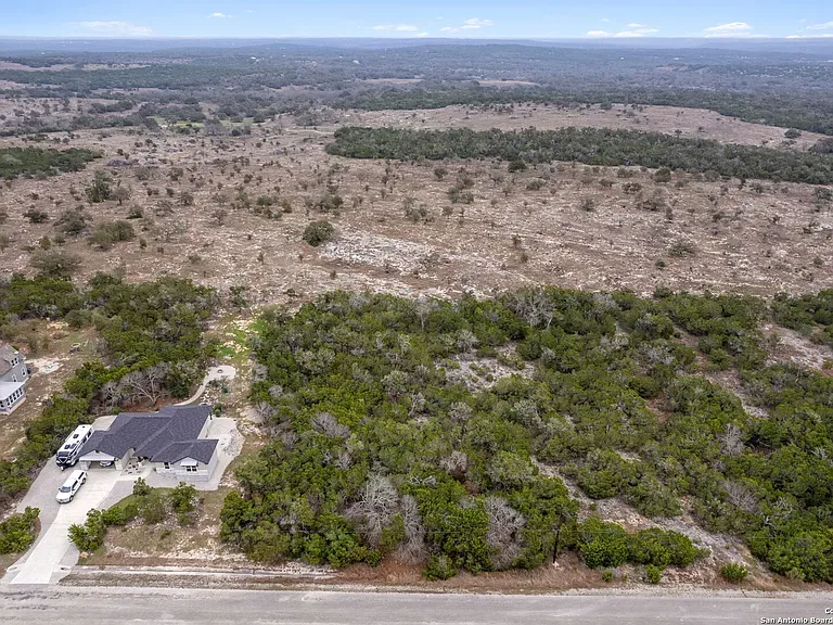 Aerial view of wooded Hill Country acreage