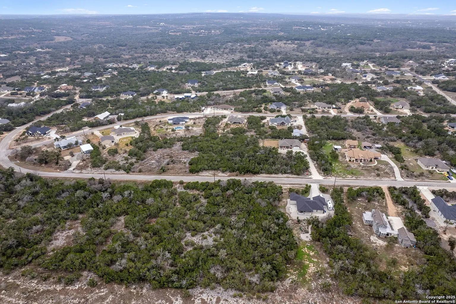 Aerial view of a Hill Country neighborhood among the oaks